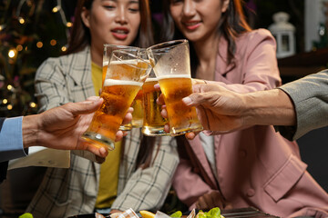 food and drink male friends are happy drinking beer and clinking glasses at a bar or pub.