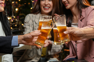 food and drink male friends are happy drinking beer and clinking glasses at a bar or pub.
