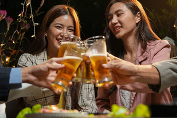 food and drink male friends are happy drinking beer and clinking glasses at a bar or pub.