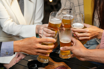 food and drink male friends are happy drinking beer and clinking glasses at a bar or pub.