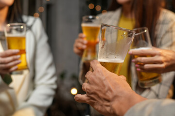 food and drink male friends are happy drinking beer and clinking glasses at a bar or pub.