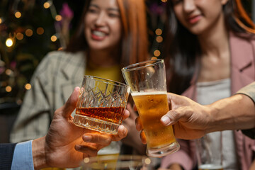 food and drink male friends are happy drinking beer and clinking glasses at a bar or pub.