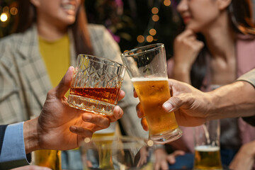 food and drink male friends are happy drinking beer and clinking glasses at a bar or pub.