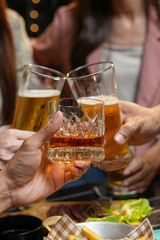  
food and drink male friends are happy drinking beer and clinking glasses at a bar or pub.