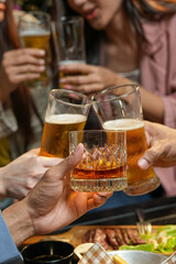  
food and drink male friends are happy drinking beer and clinking glasses at a bar or pub.