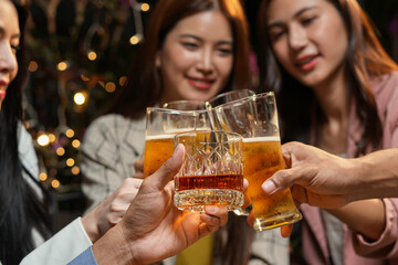 food and drink male friends are happy drinking beer and clinking glasses at a bar or pub.