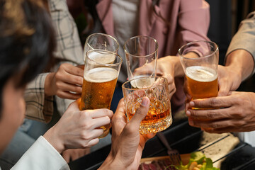 food and drink male friends are happy drinking beer and clinking glasses at a bar or pub.