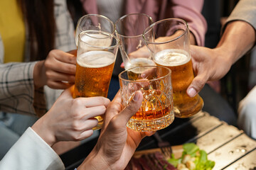 food and drink male friends are happy drinking beer and clinking glasses at a bar or pub.