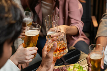 food and drink male friends are happy drinking beer and clinking glasses at a bar or pub.