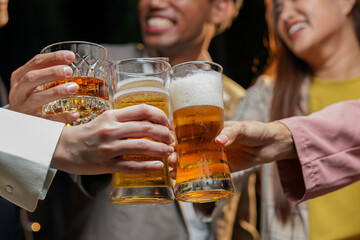 food and drink male friends are happy drinking beer and clinking glasses at a bar or pub.