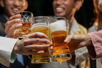 food and drink male friends are happy drinking beer and clinking glasses at a bar or pub.