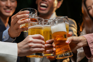 food and drink male friends are happy drinking beer and clinking glasses at a bar or pub.