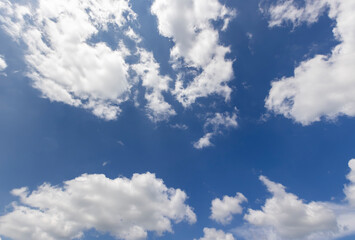 beautiful blue sky with lush white clouds in sunny bright weather