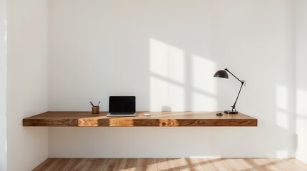 Minimalist floating wooden desk with laptop and task lamp in modern home office workspace