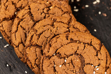 round chocolate biscuits with white sesame seeds and cocoa powder
