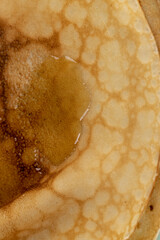 large pancakes made from milk and flour, hot pancakes made from milk with wheat flour with honey