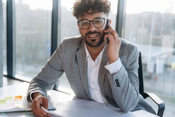 Making a deal, phone call. Businessman is sitting in the office