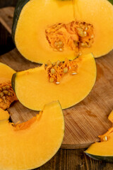 cut juicy yellow pumpkin for cooking, cut into pieces pumpkin in the kitchen, close up