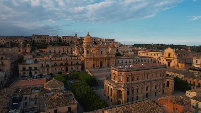 Noto&rsquo;s Cathedral of San Nicol&ograve; and surrounding baroque buildings. Scenic aerial sunset drone. Sicily