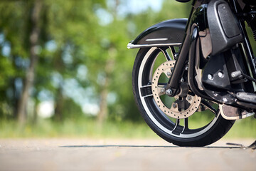 Touring motorbike detailing. Motorcycle front part close up selective focus shot with copy space....