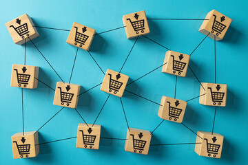 Wooden blocks with shopping cart icons connected in a network, symbolizing e-commerce and online retail.Concept for online marketplace,digital shopping.