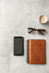 Flat lay image with blank screen phone, closed notebook, glasses, and coffee mug on stone surface to highlight awareness