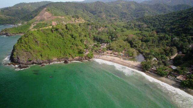 Playa osma, tropical beach surrounded by lush green mountains, aerial view