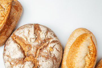 Freshly baked bread varieties on a light background in a kitchen setting