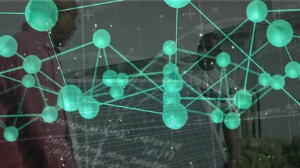 Senior technician tilting solar panel outdoors while colleague pointing network showing energy flow - Powered by Adobe