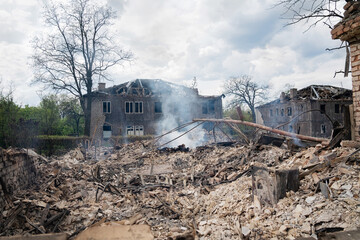 A completely destroyed apartment building as a result of Russian shelling. The photo shows smoke after a fire caused by an explosion