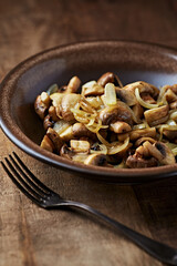 Onion with mushrooms. Rustic wooden background.	