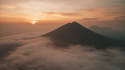 Mountains above clouds at golden sunrise