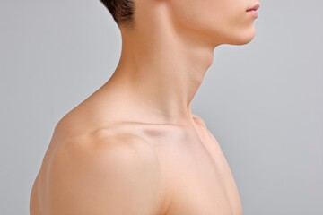 Cropped View of a Fit Individual Showcasing Collarbone Definition, Perfect Posture, and Healthy Skin Tone in a Minimalist Setting That Emphasizes Athleticism and Physical Fitness