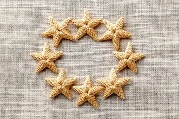Twelve Small Golden Stars Arranged in a Circular Pattern on a Textured Fabric Background