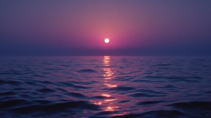 Sunset over water with reflection creating a path of light.