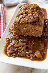 Delicious meatloaf with brown onion sauce fresh and homemade cooked