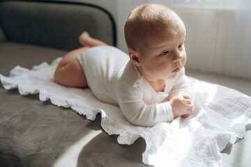 Soft white towel. Cute little baby is lying down