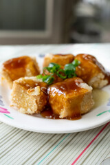 Taiwanese stinky tofu, deep-fried to a golden crisp on the outside while remaining soft inside, served with pickled cabbage and a spicy garlic sauce. This pungent yet beloved street food dish