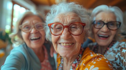 Three cheerful elderly women with curly gray hair are laughing and taking a selfie together, showcasing joy and connection in a beautifully decorated indoor setting.