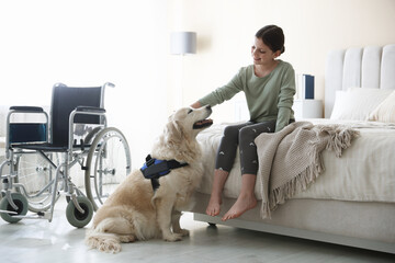 Girl with disability and her service dog at home