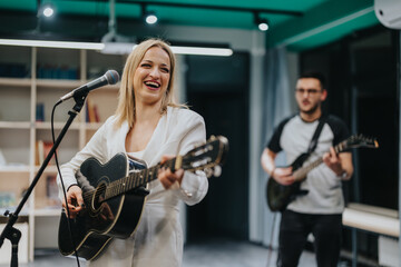 A group of musicians plays acoustic and electric guitars in a brightly lit rehearsal studio. The...