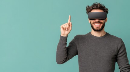 Naklejka premium A man wearing VR headset, smiling and pointing upward against a teal background. He's excited and engaged