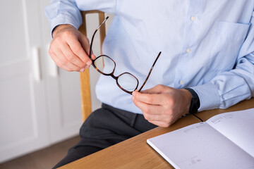 Businessman with planner on desk setting work goals