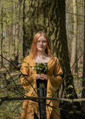 young woman in medieval dress in spring forest