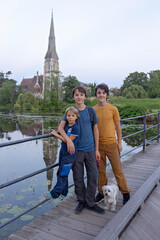 Family with children and pet dog, kids and adults visiting Coppenhagen , capital city of Denmarn during summer