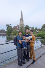 Family with children and pet dog, kids and adults visiting Coppenhagen , capital city of Denmarn during summer