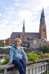 Family with children and pet dog, visiting nortern cities in Sweden, Uppsala