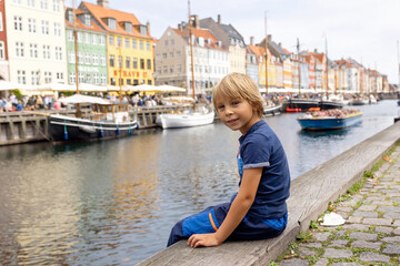 Family with children and pet dog, kids and adults visiting Coppenhagen , capital city of Denmarn during summer
