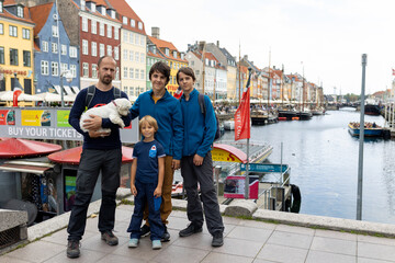 Family with children and pet dog, kids and adults visiting Coppenhagen , capital city of Denmarn during summer
