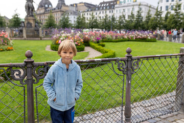 Family with children and pet dog, kids and adults visiting Coppenhagen , capital city of Denmarn during summer